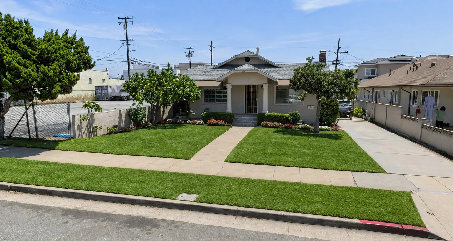 The West San Gabriel Valley facility at 1416 South Monterey Street in Alhambra: a single-storey craftsman house with a covered porch, trimmed lawn and flowering beds along the walkway.